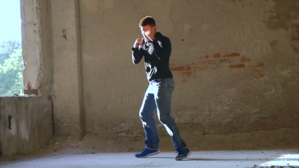 Kickboxer shadow boxing as exercise for the big fight in catacomb. Slow motion — Stock Video