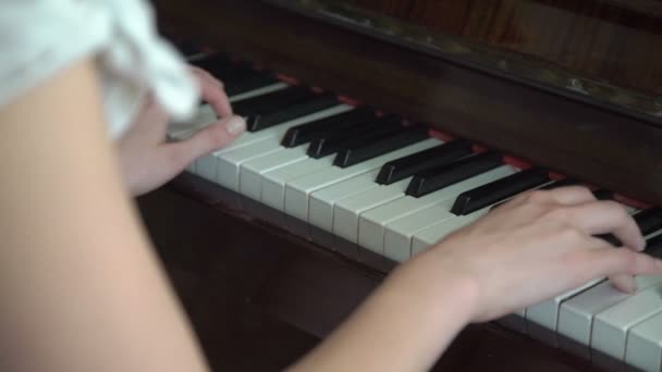 Young hands playing on the piano keyboard — Stock Video