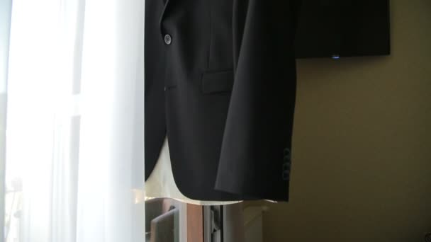 Grooms jacket on hanger in room on window — Stock Video