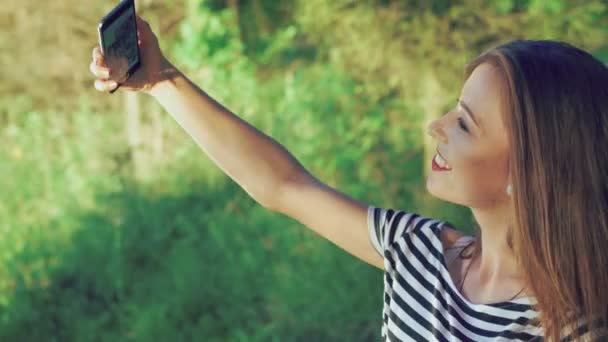 Jolie brune prenant selfie dans le parc. 4k 