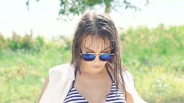 Islak kadın etrafında dönen ve gülümseyen mayo. Yavaş yavaş