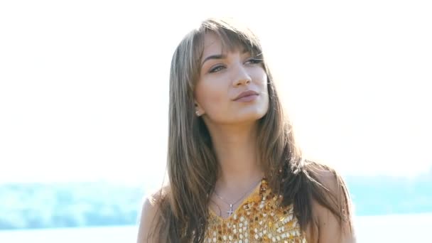 Portrait of pretty woman posing on camera on river background. Slowly — Stock Video