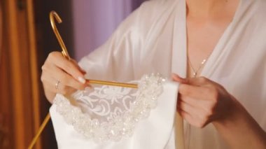 Mutlu gelin görünüyor ve gelinlik yatak üzerinde çalışır