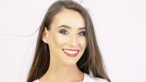 Portrait of smiling girl looking on a camera on beige background. Slowly — Stock Video