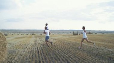 Güzel anne, kocasını ve kızını tarlada solluyor.