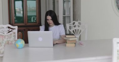 Masada dizüstü bilgisayarla çalışan güzel bir kız öğrenci.