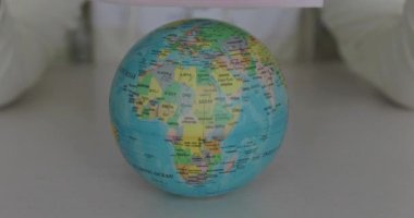 Close view of tightening the globe with a medical mask at camera