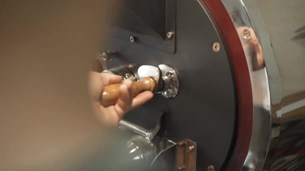 Male hands controlling the process of preparing coffee beans — Stock Video