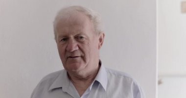 Arka planda kameraya gülümseyen yakışıklı son sınıf öğrencisinin portresi.