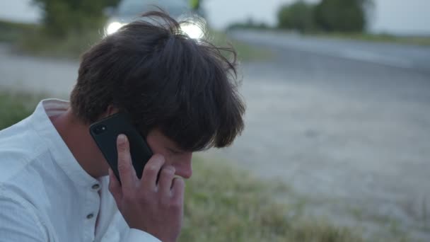 Close up mans face that waits on the phone line — Stock Video