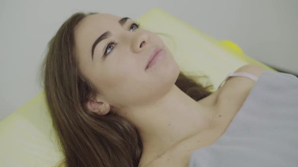 Портрет красивой девушки, лежащей на диване в салоне красоты — стоковое видео