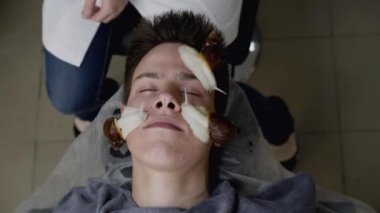 Güzellik uzmanları, kaplıcadaki erkek yüzünden sürünen salyangozları bırakırlar.