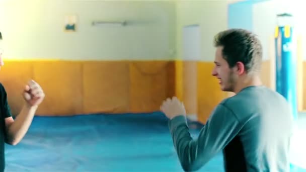 Тренировка кикбоксёра в боксерской груше — стоковое видео