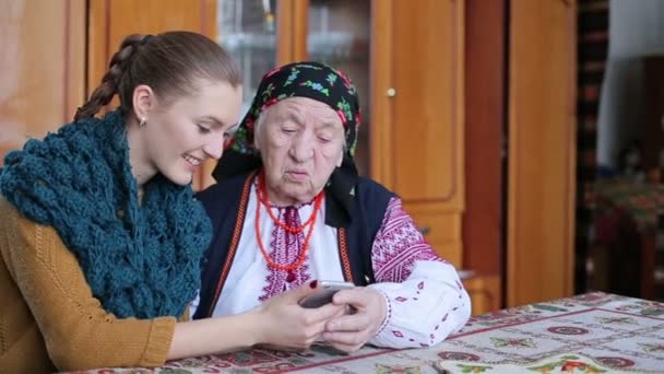 Бабушка смотрит на мобильный телефон — стоковое видео