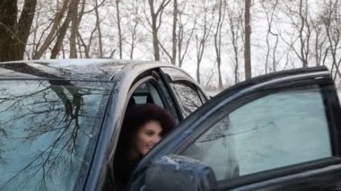 Girl near the car in winter