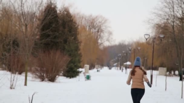 Beautiful girl running in winter — Stock Video