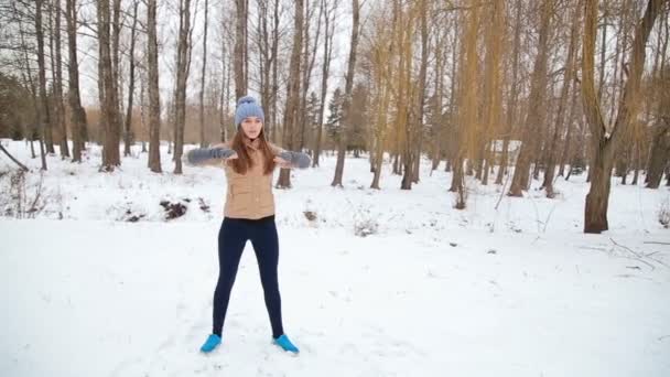Женщина занимается спортом в парке зимой — стоковое видео