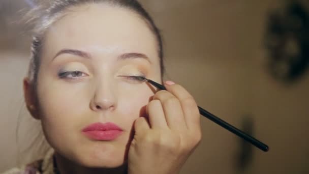 Schönes Mädchen macht ein Make-up — Stockvideo