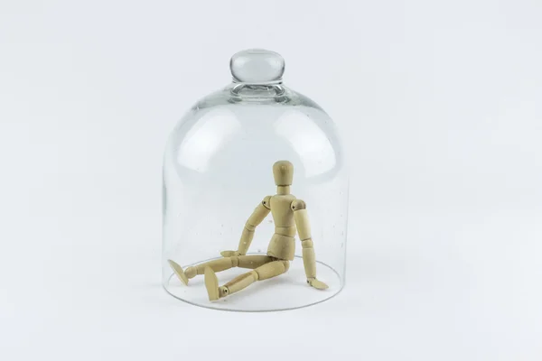 Wooden puppet in a glass bell — Stock Photo, Image