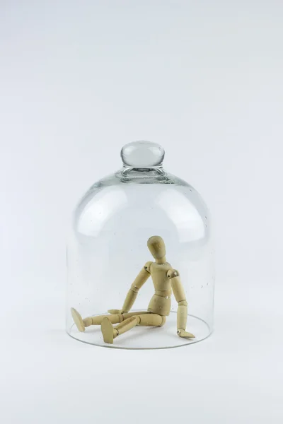 Wooden puppet in a glass bell — Stock Photo, Image