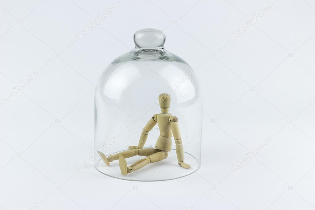 Wooden puppet in a glass bell