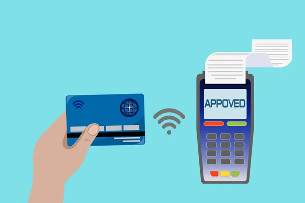 hand holds a credit card with a payment terminal on a blue background. Contactless payment concept