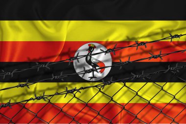 Uganda bayrağı geliştirme, tel örgüler ve dikenli teller. Göçmenler izolasyon kavramı. Metnin için yer.