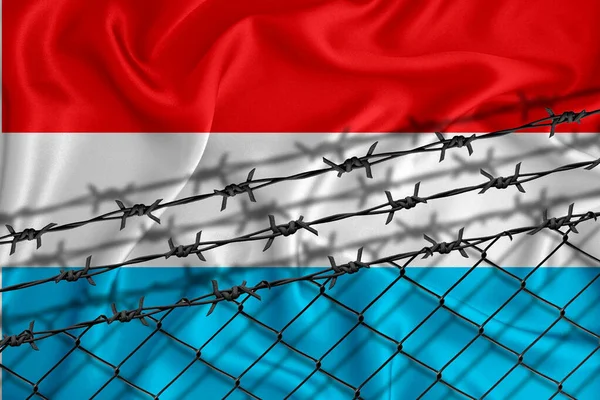 Luxembourg flag development, fence mesh and barbed wire. Emigrants isolation concept. With place for your text.