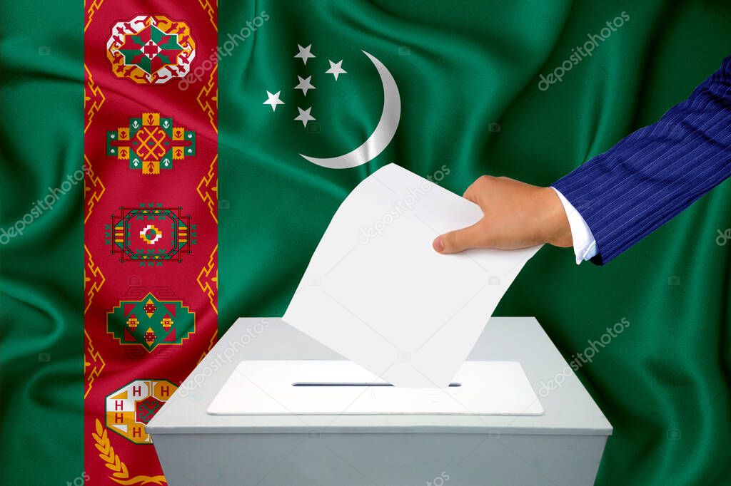 Elections in the country - voting at the ballot box. A man's hand puts his vote into the ballot box. Flag turkmenistan on background.