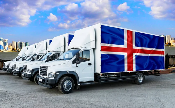 Iceland flag on the back of Five new white trucks against the backdrop of the river and the city. Truck, transport, freight transport. Freight and Logistics Concept