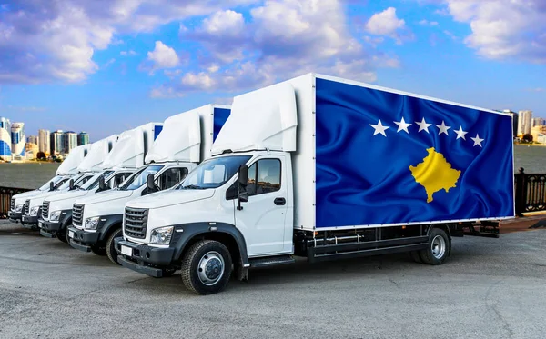 kosovo flag on the back of Five new white trucks against the backdrop of the river and the city. Truck, transport, freight transport. Freight and Logistics Concept