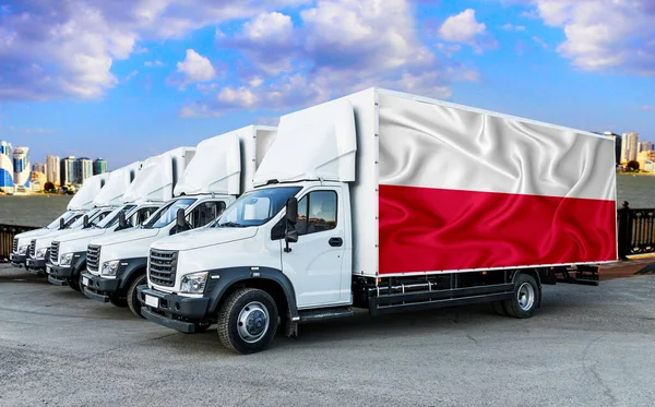 Poland flag on the back of Five new white trucks against the backdrop of the river and the city. Truck, transport, freight transport. Freight and Logistics Concept