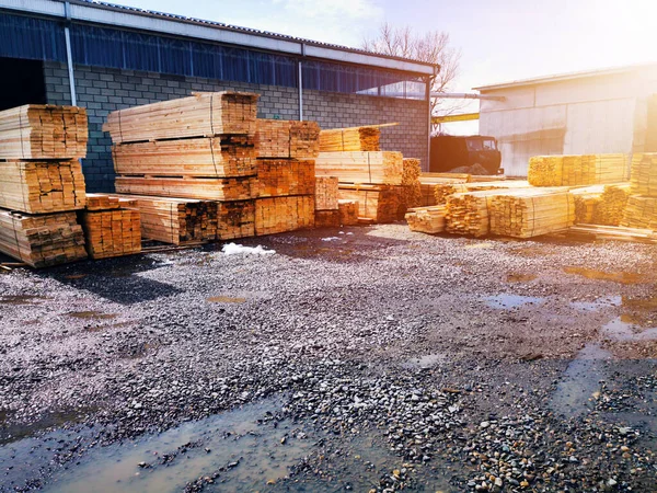 Wood warehouse. Lumber logs, boards and beams basic building material. Industrial plant sawmill - storage of wooden boards