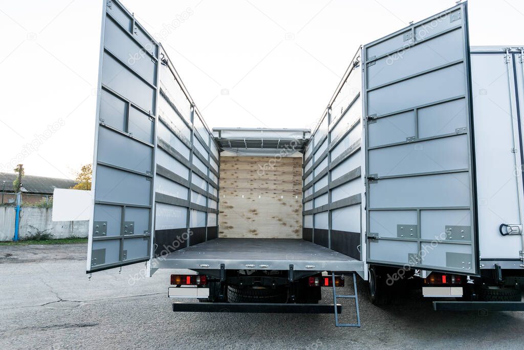 Loading white trucks at the facility. Delivery or shipment of goods conceptual image.