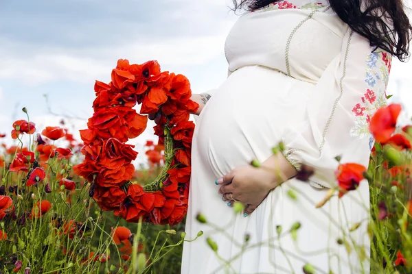 Femme enceinte sur le champ de pavot — Photo