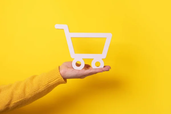 Trolley Hand Yellow Background Buying Online Concept — Stock Photo, Image