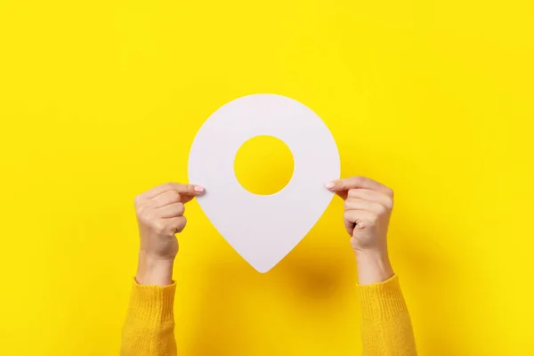 white map pointer 3d pin  in hand over yellow background