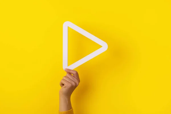 Hand Holding Media Play Button Yellow Background — Stock Photo, Image