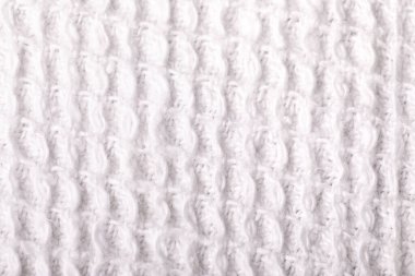 Yumuşak beyaz waffle kumaş dokulu örgü deseni gösteren yakın plan, arka plan, tekstil veya tasarım modelleri için idealdir.