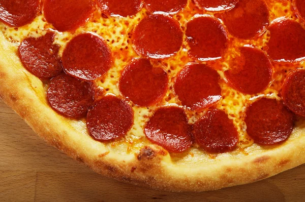 Italian pizza pepperoni on wooden background — Stock Photo, Image