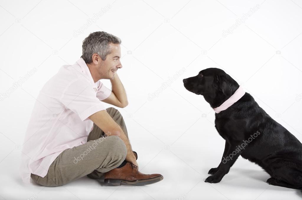 man playing with Labrador dog