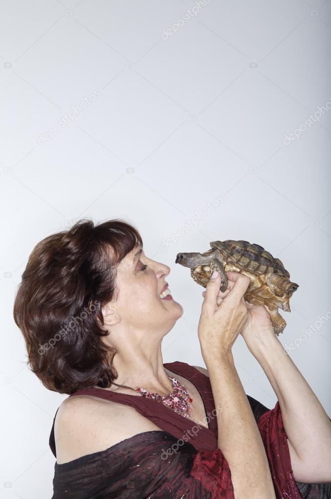 Woman playing with turtle 