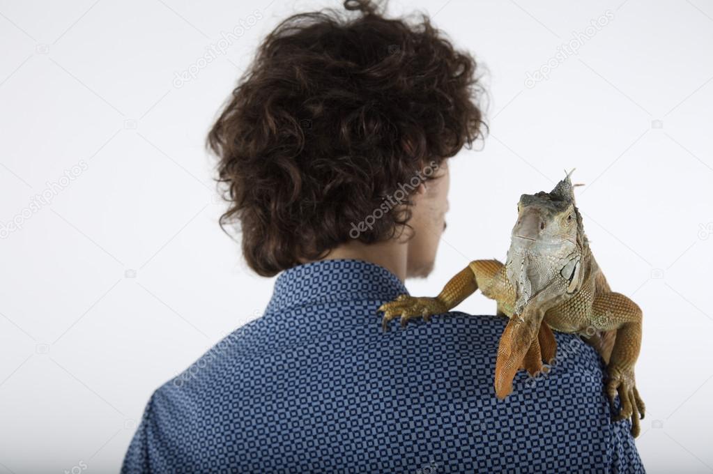 young man with iguana on shoulder