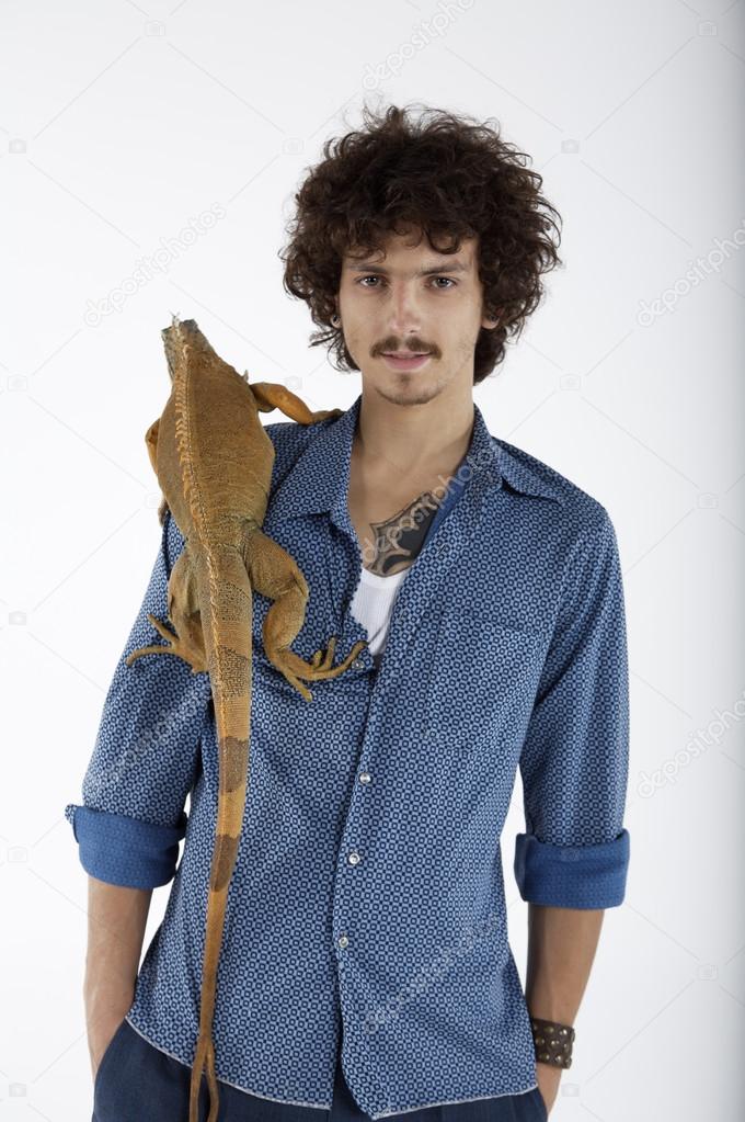 young man with iguana on shoulder