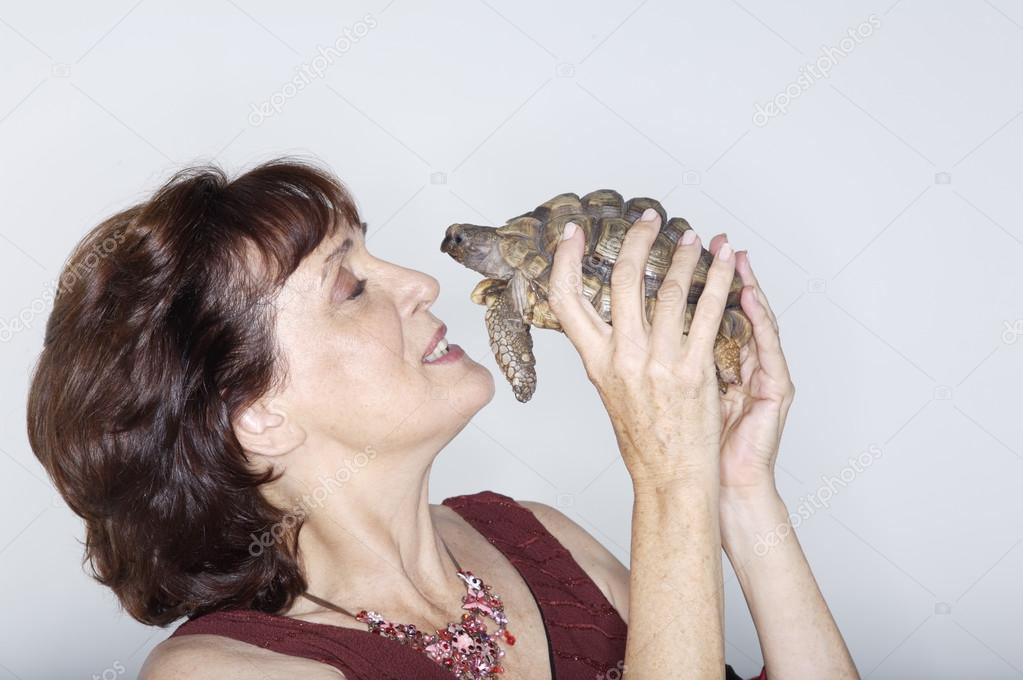 Woman playing with turtle 