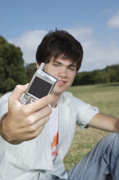 Tizenéves fiú gazdaság mobiltelefon — Stock Fotó
