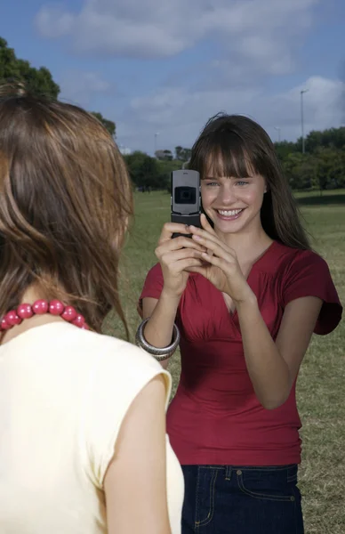 Tizenéves lány figyelembe képet a telefon — Stock Fotó