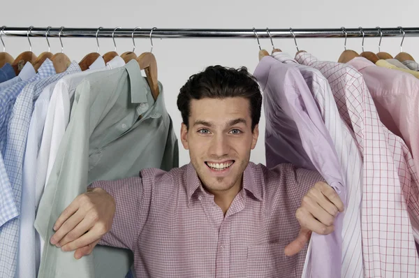 Man with row of different shirts — Stock Photo, Image