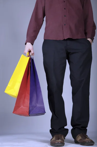 man holding shopping bags