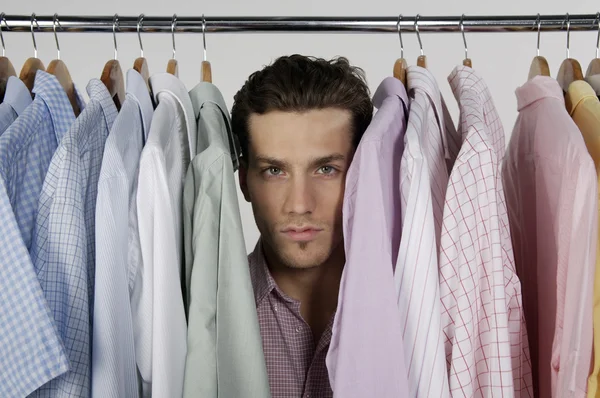 Man in row of different shirts — Stock Photo, Image